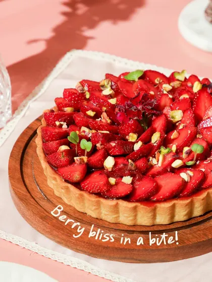 Berry bliss in a bite! Our delightful strawberry tart features a buttery crust, creamy filling, and a beautiful arrangement of fresh strawberries topped with pistachios.