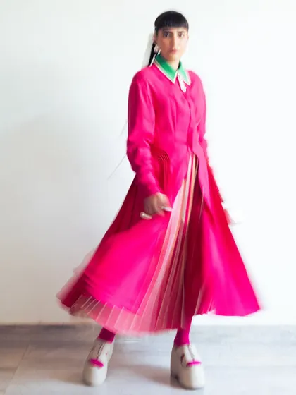 A motion-blur photo showing the vibrant color and movement of my pink Bodice dress, worn for their fashion show.