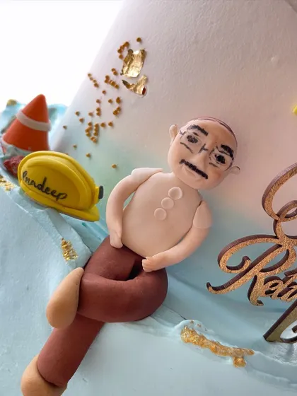 A close-up of the handmade caricature topper for the retirement cake. I love adding these personal touches to make the cake truly unique.