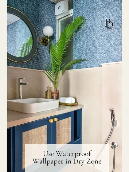 You don't need a full demolition to elevate a builder-grade bathroom. This space was transformed with simple but impactful additions like waterproof wallpaper in the dry zone, a chic mirror, and stylish wall sconces to add character and a custom-designed feel.