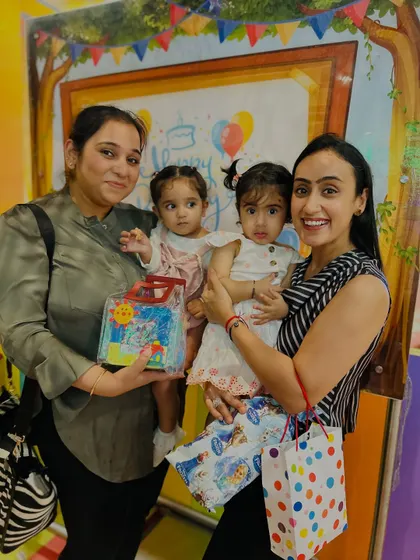 A group photo after a birthday party, with everyone holding gifts and smiling. We believe in celebrating every child.