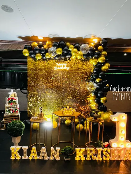 This glamorous black and gold theme is a popular choice for first birthdays. The combination of a full sequin wall, a dense balloon garland, and custom light-up marquee letters creates a grand and celebratory feel.