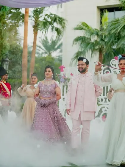 The couple glides through a path of smoke, escorted by performers, making their Mehendi entry a truly mesmerizing and theatrical spectacle.