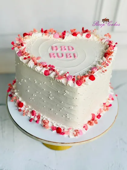 A heart full of flowers and a cake full of love. This beautiful heart-shaped cake is perfect for celebrating someone special.