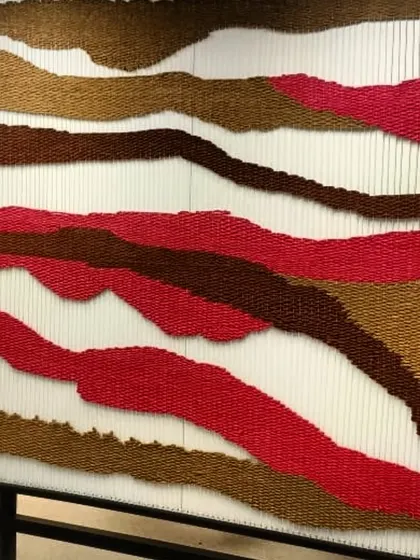A close-up of another tapestry piece from the Hyderabad project, this one with a fiery palette of reds and browns.