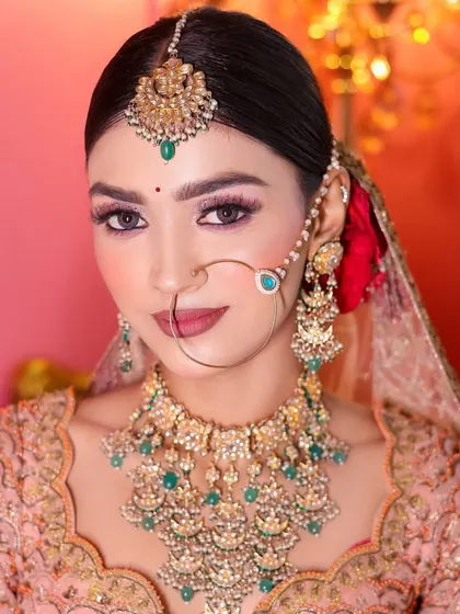 Another angle of this pink-themed bridal look, showing the beautiful details of the jewelry and makeup.