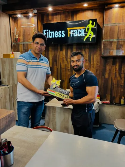Presenting another first-place award to one of our dedicated athletes. Success is a team effort, and we are proud of our champions.
