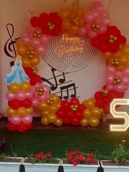 A princess-themed ring decoration for a 5-year-old's birthday party in a Noida banquet. The red, pink, and gold balloons with princess cutouts create a royal celebration.