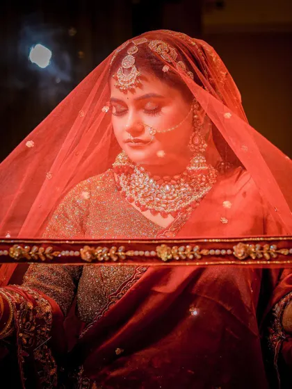 A traditional pose under the veil, conveying a sense of timeless bridal elegance.