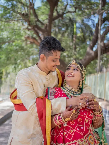 A happy, candid moment between the bride and groom, their smiles radiating joy on their wedding day.