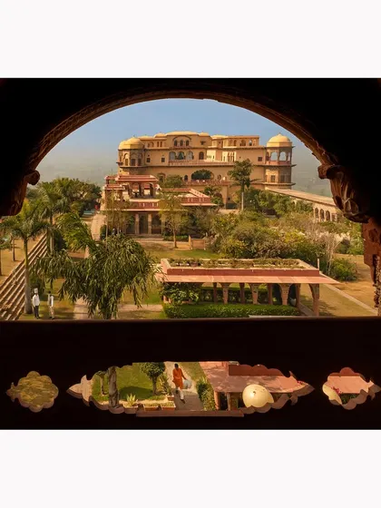 Looking out from an ornate window, this shot frames the exterior of the fort like a painting. It highlights the detailed craftsmanship and provides a unique perspective on the property's architecture.
