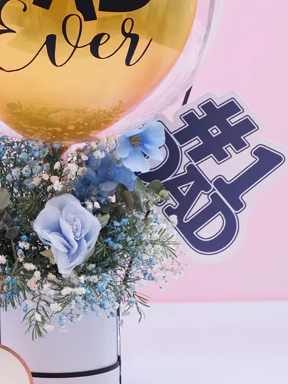 Another detail of the Father's Day bouquet, highlighting the beautiful blue florals and the "Best Dad Ever" balloon.
