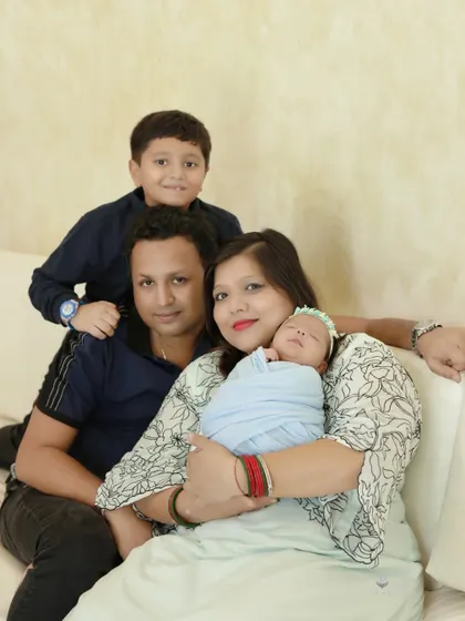 A relaxed and happy family portrait on the couch. This image captures the comfortable and loving atmosphere of the family at home.