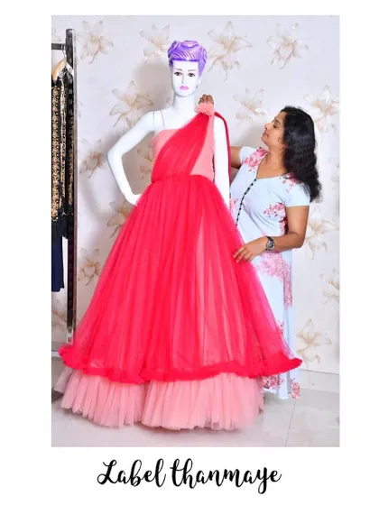 Adjusting the drape on a one-shoulder gown. Every detail is important to get the perfect look.