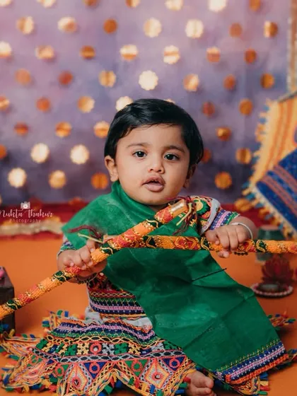 Holding her dandiya sticks, this little cutie is ready for the Garba celebration. I love capturing the spirit of Indian festivals.