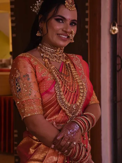 Another portrait of the bride, showcasing the elegant fall of the pre-pleated Kanjivaram saree.