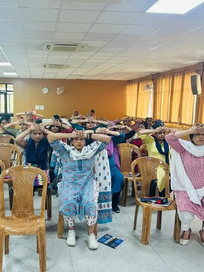 The teachers participating in a simple chair exercise. It's amazing to see jejich enthusiasm for learning about fitness.