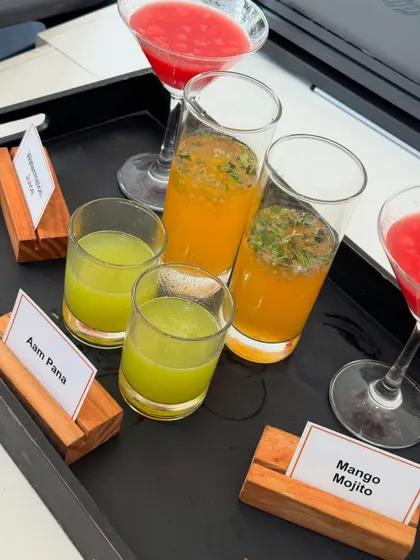 A selection of our refreshing welcome drinks. This tray features classic Aam Panna, a summery Mango Mojito, and a vibrant Watermelon drink, beautifully presented for a corporate event.