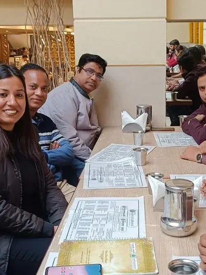 A casual team meeting over lunch with senior and junior advocates. These informal discussions are often very productive.