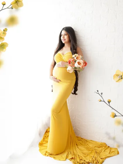 Glowing and growing. This mama-to-be looks radiant in a bright yellow bodycon gown that beautifully accentuates her baby bump, with floral elements adding a soft, artistic touch.