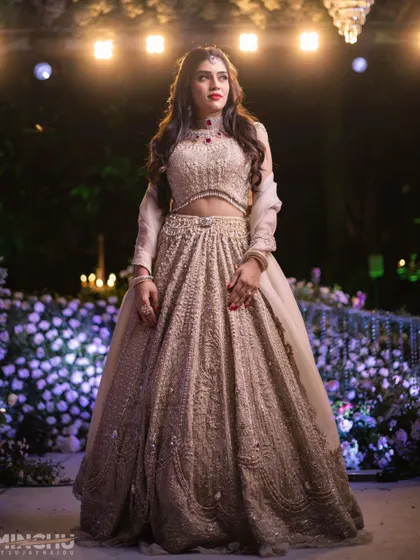 Mahima looking ethereal at her engagement party. Her makeup is soft yet glamorous, complementing the dreamy floral decor and the sparkle of her lehenga.
