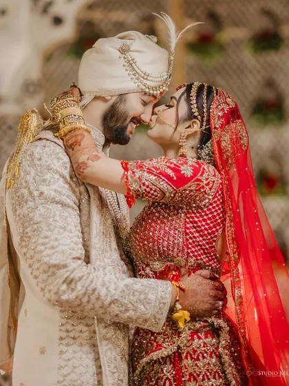 An intimate and happy moment, with the couple sharing a nose-to-nose kiss, full of smiles.