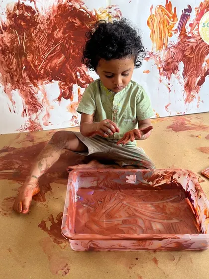 This image captures the essence of our Messy Artist sessions. It’s not about a perfect painting, but about the rich, tactile experience of feeling the paint and seeing the colors mix. This is where a child's confidence in their own abilities begins.