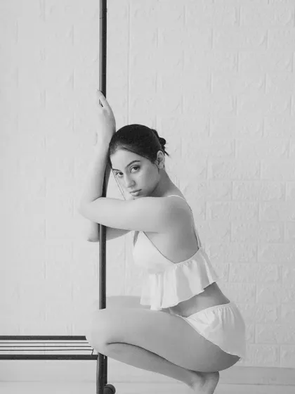 A quiet, gentle portrait in black and white. The pose is soft, and the lighting is diffused and even.