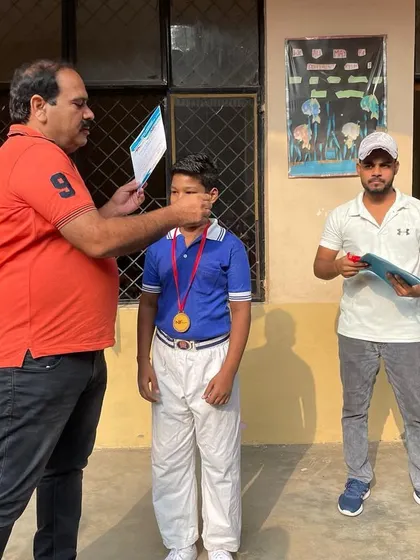 A student receiving his medal and certificate at a school ceremony. I am there to support my champions during their moments of achievement.