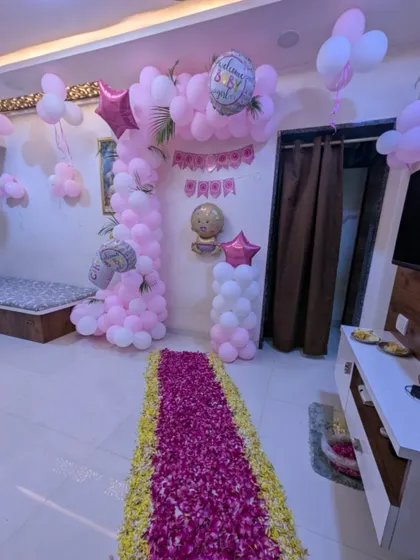 Another angle of the pink-themed welcome baby decor, showing the balloon pillar and 'Welcome Baby' foil balloons that add to the festive look.