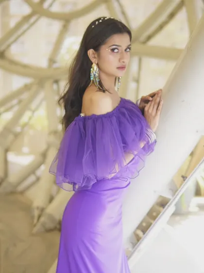 Another angle of the purple mermaid gown, highlighting its flattering silhouette and modern details.