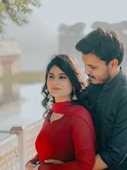 A tender embrace with the soft morning light reflecting off the water at Jal Mahal. This is a perfect example of a quiet, romantic pre-wedding portrait.