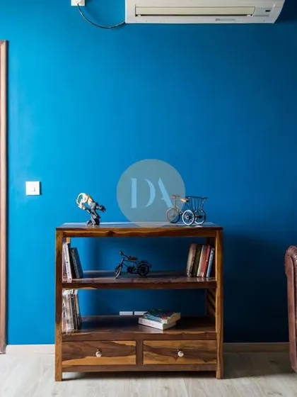 Another view of the bold blue lounge area, featuring a classic Chesterfield sofa. This space demonstrates our love for using dark, captivating colors to create depth and character in a room.