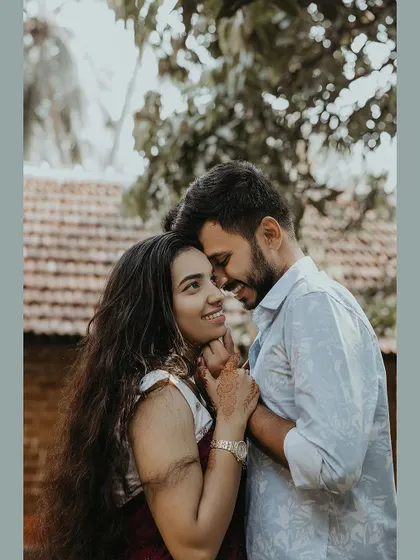 A close-up of a couple sharing a loving and happy moment in a garden.