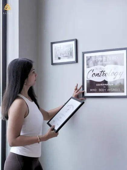 Pilates is a holistic transformation. Here, I'm arranging the inspirational art in my studio, which serves as a constant reminder of the mind, body, and spirit connection.