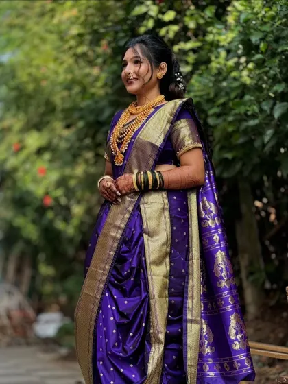 A side view of the purple bridal Nauvari, showing the neatness of the pleats and the way the saree is secured for a perfect fit.