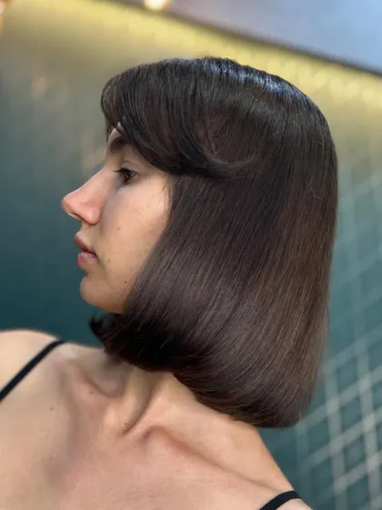 The timeless allure of a classic brown hue on a chic bob. This look is sophisticated and effortlessly stylish.