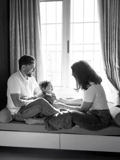A quiet moment by the window can say so much. Using beautiful natural light, I create timeless, soulful black and white portraits that capture the peaceful comfort of being at home with the ones you love.