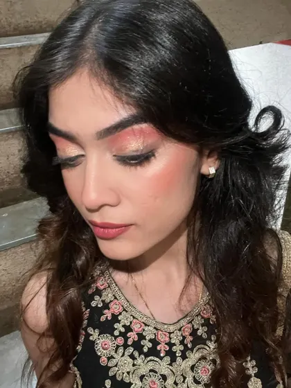 A detailed shot of the eye makeup, showing the winged liner and glittery shadow.