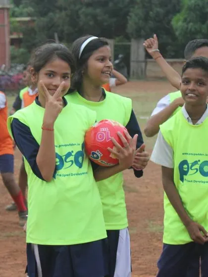 Young participants, smiling and wearing bibs, enjoy the Children's Day activities. Our goal is to make sports accessible and enjoyable for all children.