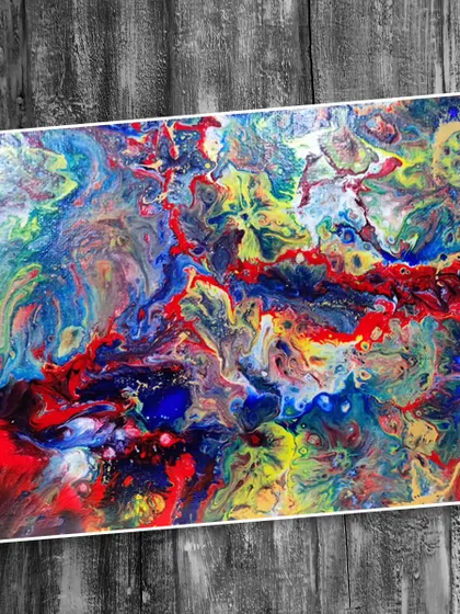 A vibrant and dynamic fluid art canvas with a rainbow of colors. This shows the expressive potential of paint pouring, a technique we teach in our workshops.