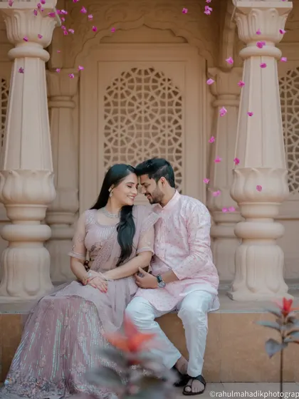 I love creating grand, fairytale-like images. Here, we used the stunning architecture to frame the couple, with flower petals adding a touch of magic. This is for couples who dream of a pre-wedding shoot that feels both royal and romantic.