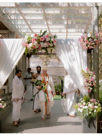 The groom, Alan, making his way to the mandap in traditional Indian attire, ready to embrace the customs of his bride's culture.
