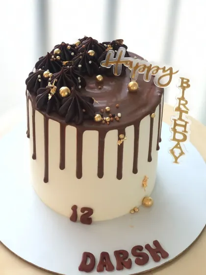 A classic chocolate drip cake for a 12th birthday, with rich chocolate frosting and gold details.