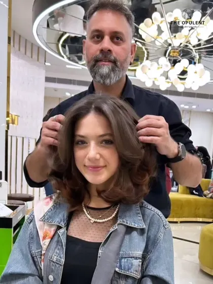 Another angle of this stunning layered haircut. The shape and volume are expertly crafted to create a glamorous and sophisticated look.