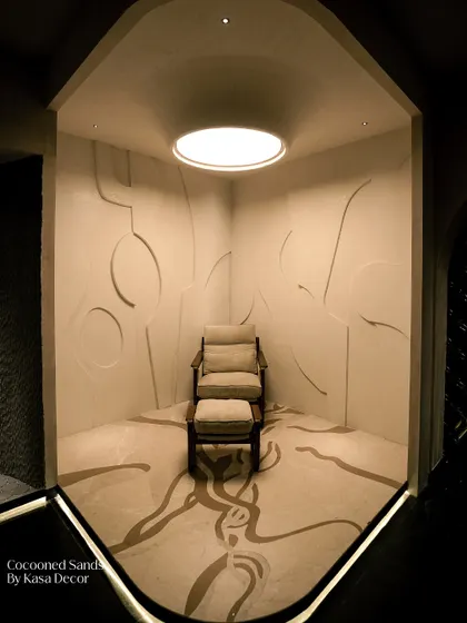 A private, meditative space defined by our 'Cocooned Sands' surface. The abstract, organic lines carved into the walls and floor create a seamless, enveloping feel, proving that a room can be both minimal and deeply expressive.