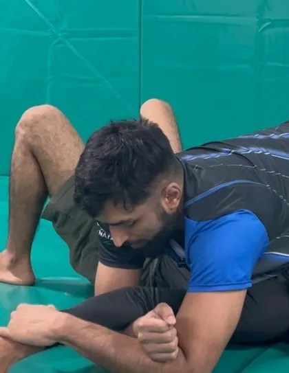 A close-up of the Americana lock being applied from side control. Our classes focus on these fundamental submissions to build a strong grappling foundation.