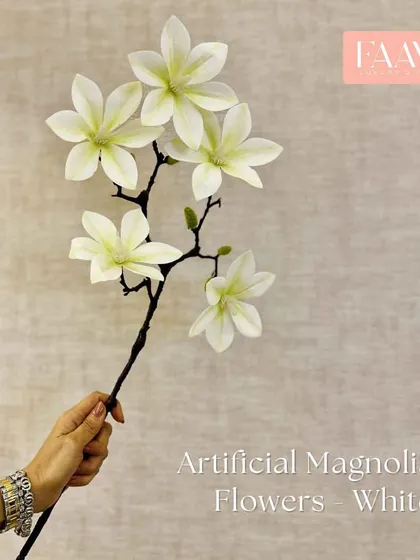 Our artificial white magnolia flower branch has a delicate, life-like quality. It is perfect for creating tall, architectural arrangements in a floor vase.