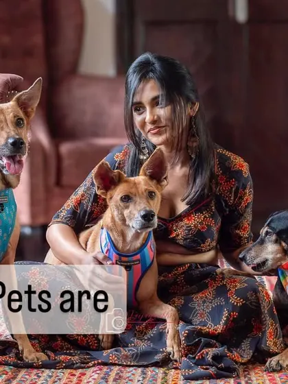 A beautiful woman with her three indie dogs, illustrating the point that pets are like potato chips, you can't have just one!