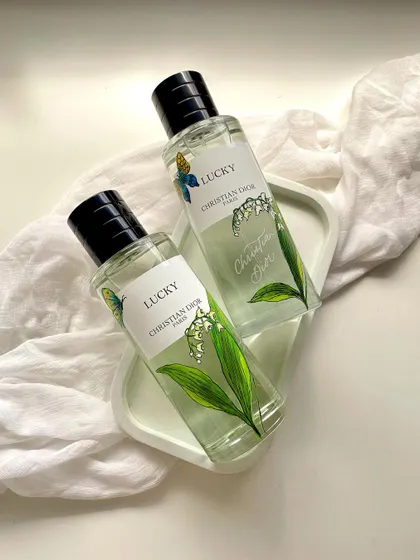 An example of my hand-painted customization work on a Christian Dior fragrance bottle. For this 'Lucky' perfume, I painted delicate lily of the valley illustrations to complement the scent's notes, creating a personalized and luxurious gift.